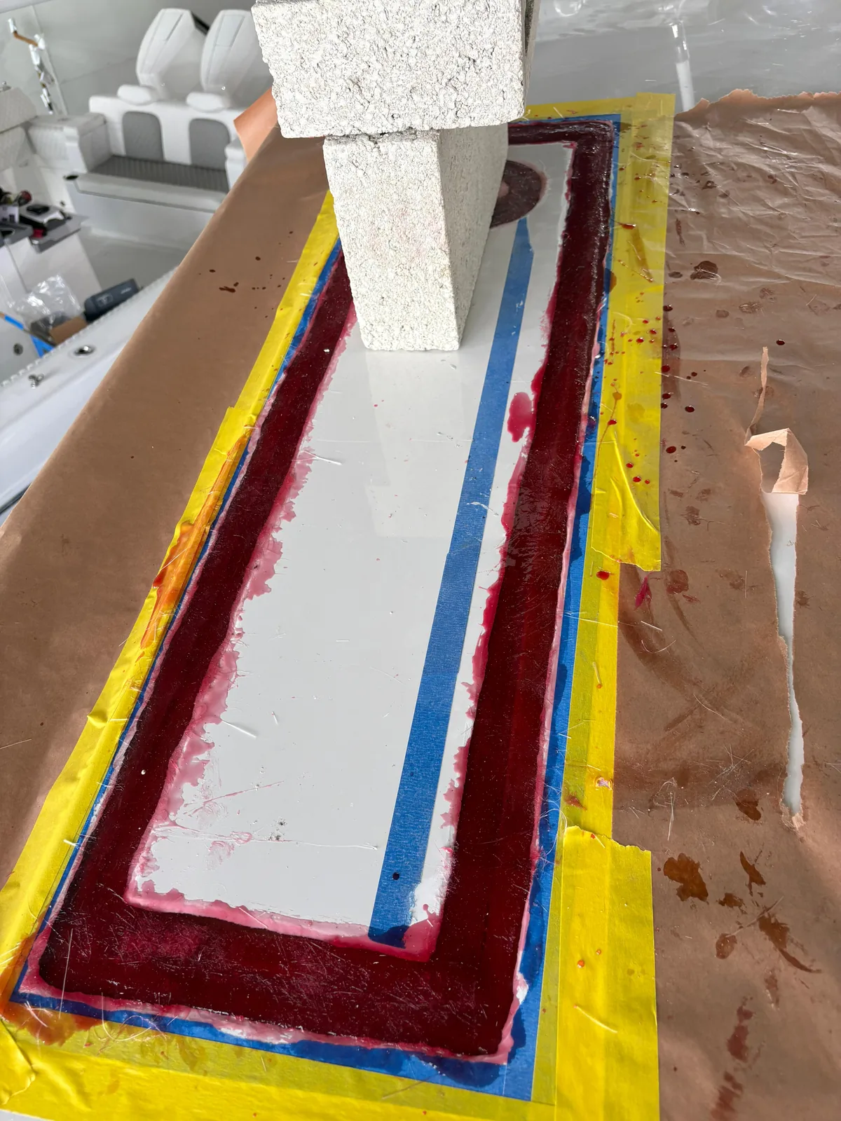 Hardtop panel under resin lamination with masking paper and a curing weight in place